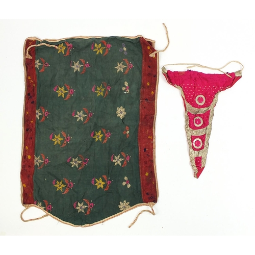 111 - Middle Eastern and Indian textiles including an embroidered skirt, Palestinian style hanging, two si... 