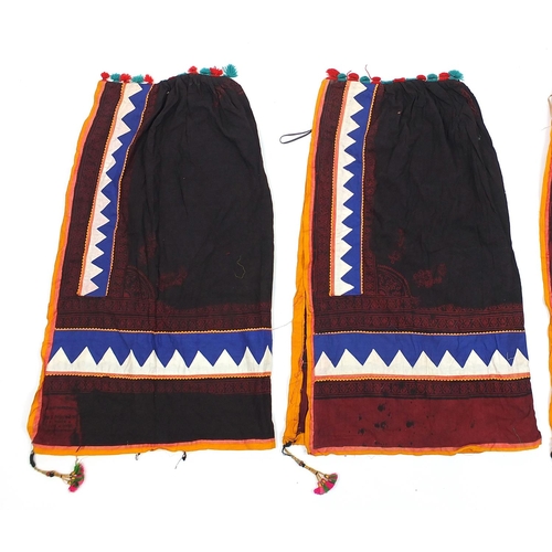 173 - Three Middle Eastern or Indian textiles, possibly cloaks, each approximately 95cm high