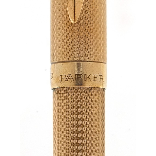 414 - Parker 9ct gold ballpoint pen with engine turned body, 18.3g