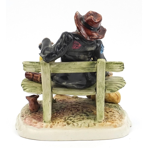 20 - Hand painted Capodimonte figure of a tramp on a bench, 26cm high