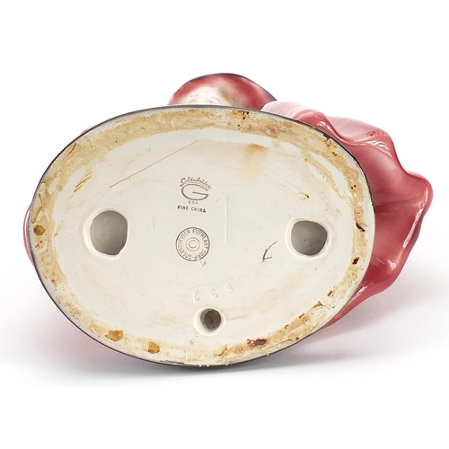 154 - Goldschneider, Czechoslovakian Art Deco pottery figurine of a female wearing a floral dress, numbere... 