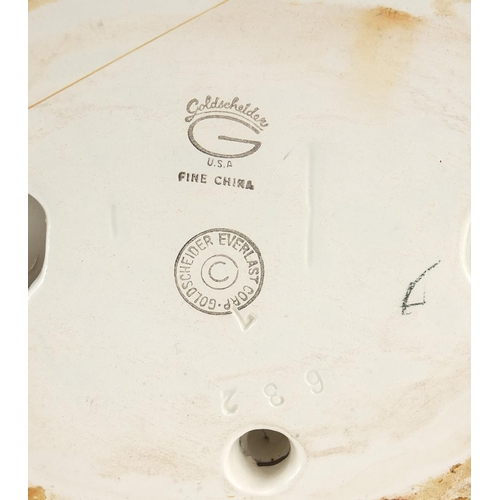 154 - Goldschneider, Czechoslovakian Art Deco pottery figurine of a female wearing a floral dress, numbere... 