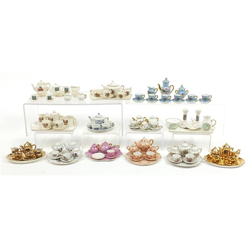 2203 - Vintage and later porcelain doll's house tea services including one decorated with flowers housed in... 