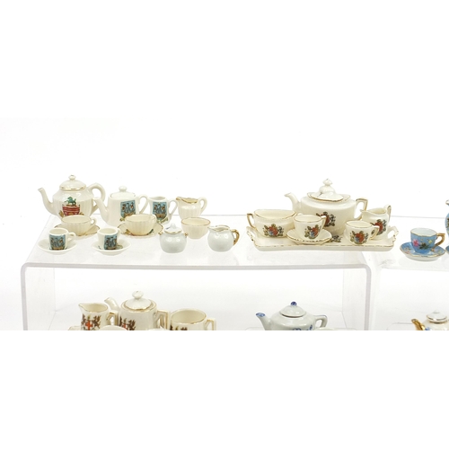 2203 - Vintage and later porcelain doll's house tea services including one decorated with flowers housed in... 