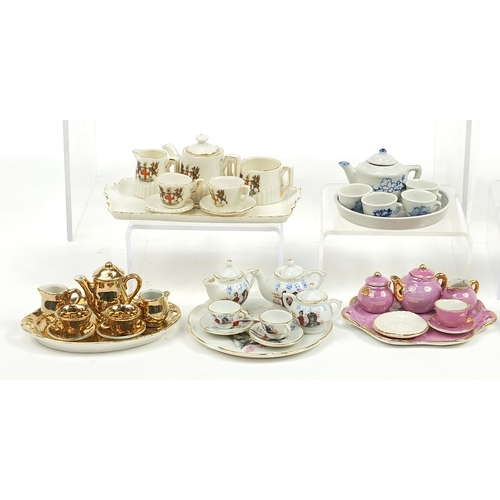 2203 - Vintage and later porcelain doll's house tea services including one decorated with flowers housed in... 