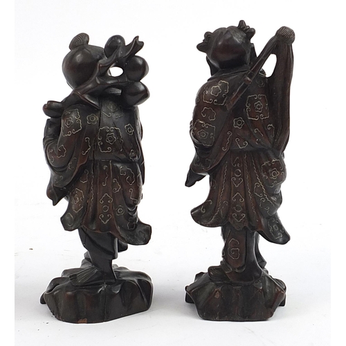 85 - Pair of Chinese carved root wood figures with white metal inlay, 20.5cm high