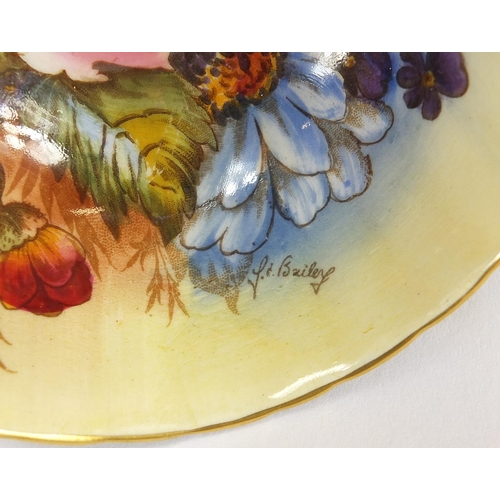 90 - Three Aynsley cups and saucers including two hand painted with flowers and one decorated with a rigg... 