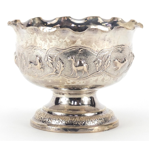 843 - Indian silver coloured metal pedestal bowl embossed with wild animals, 8cm high x 10.5cm in diameter... 