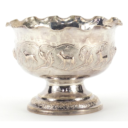 843 - Indian silver coloured metal pedestal bowl embossed with wild animals, 8cm high x 10.5cm in diameter... 