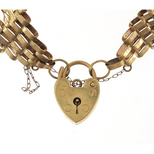 864 - 9ct gold six row gate link bracelet with love heart padlock, 17cm in length, 11.8g