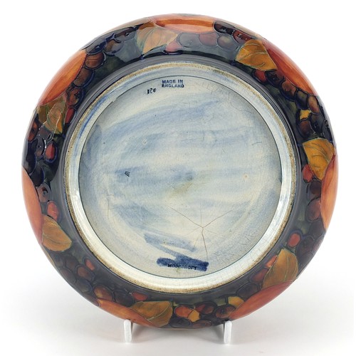 91 - William Moorcroft pottery bowl with silver plated rim hand painted with flowers, 21cm in diameter