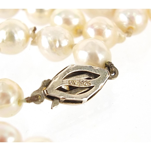 2191 - Nitto pearl necklace with silver clasp and embroidered case, 90cm in length, 51.0g