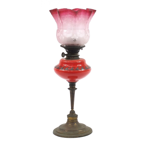 24 - Victorian brass oil lamp with etched cranberry glass shade, 58cm high