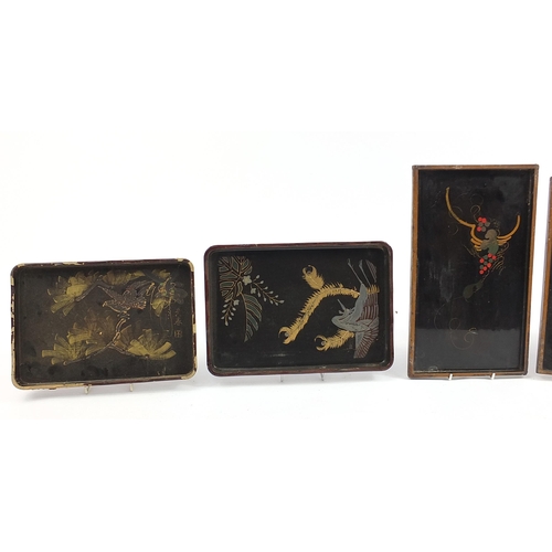 140 - Five Japanese lacquered trays hand painted with animals and flowers including a red example with sea... 