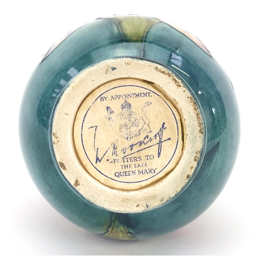 92 - Moorcroft Pottery baluster vase hand painted with two flowers, paper label to the base, 10cm high