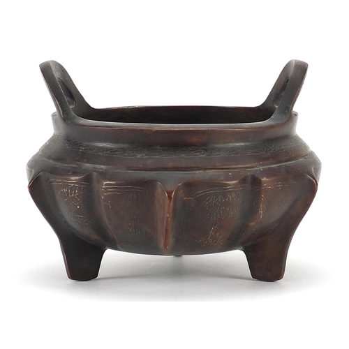 84 - Chinese patinated bronze three footed censer with silver inlay and twin handles, character marks to ... 