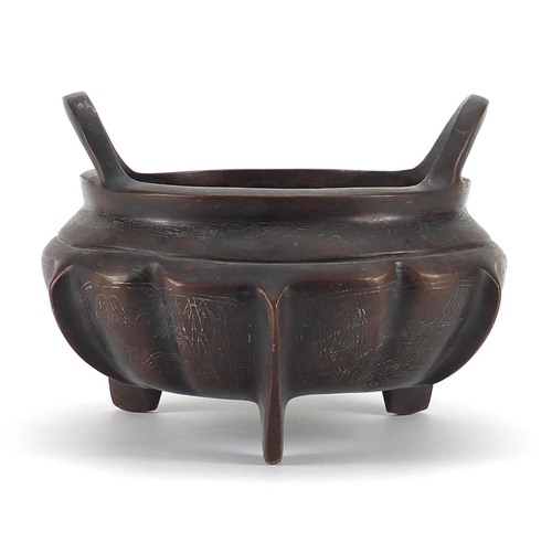 84 - Chinese patinated bronze three footed censer with silver inlay and twin handles, character marks to ... 