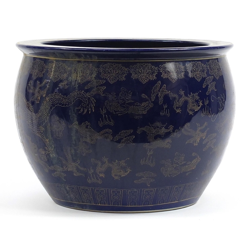 82 - Chinese cobalt blue ground jardiniere gilded with dragons chasing a flaming pearl amongst clouds, 32... 