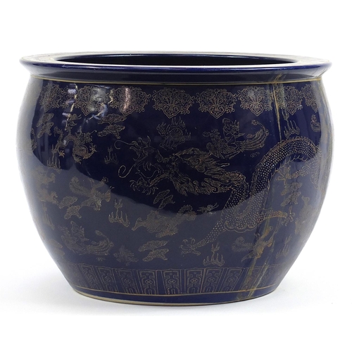 82 - Chinese cobalt blue ground jardiniere gilded with dragons chasing a flaming pearl amongst clouds, 32... 