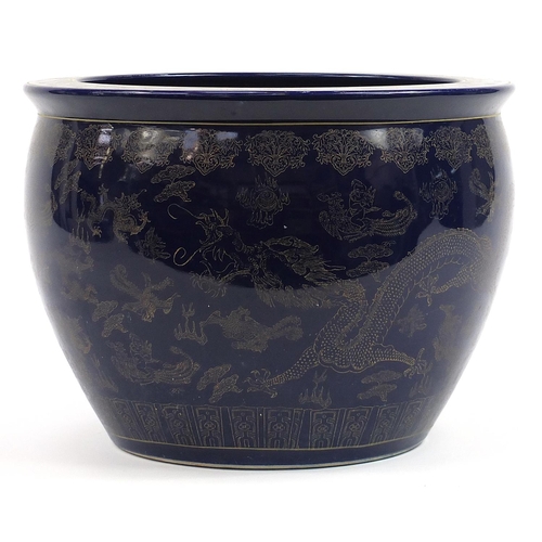 81 - Chinese cobalt blue ground jardiniere gilded with dragons chasing a flaming pearl amongst clouds, 32... 