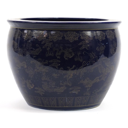 81 - Chinese cobalt blue ground jardiniere gilded with dragons chasing a flaming pearl amongst clouds, 32... 