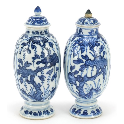 125 - Matched pair of Chinese blue and white porcelain vases and covers hand painted with panels of flower... 