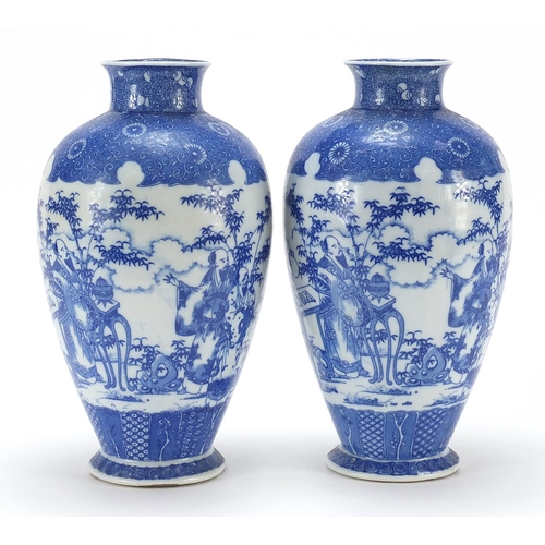 14 - Pair of Japanese blue and white porcelain vases, each decorated with scholars in a landscape, charac... 