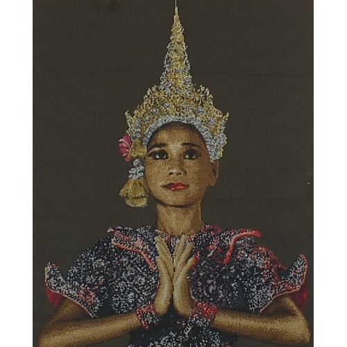 291 - Large needlepoint tapestry of a Thai female, mounted, framed and glazed, 97cm x 68cm excluding the m... 