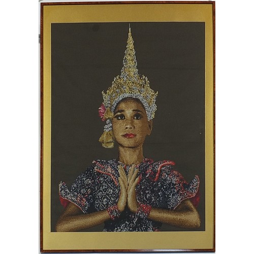 291 - Large needlepoint tapestry of a Thai female, mounted, framed and glazed, 97cm x 68cm excluding the m... 