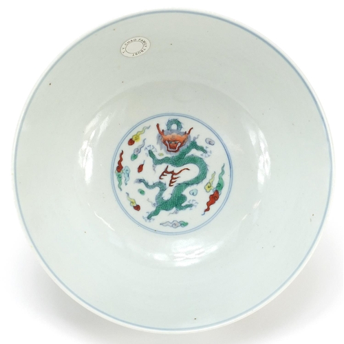 900 - Chinese doucai porcelain bowl hand painted with two dragons amongst clouds above crashing waves, six... 