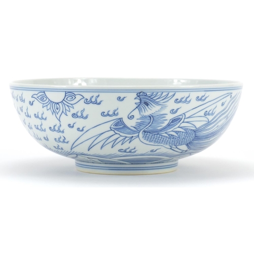 1050 - Chinese blue and white porcelain bowl hand painted with a dragon and phoenix amongst clouds, six fig... 