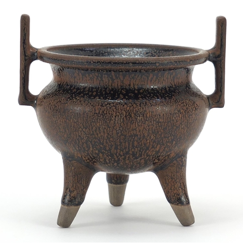 1052 - Chinese porcelain tripod censer with twin handles having a hare's fur type glaze, 10cm high