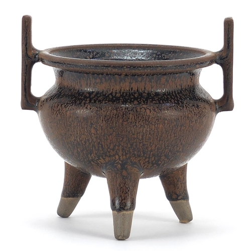 1052 - Chinese porcelain tripod censer with twin handles having a hare's fur type glaze, 10cm high