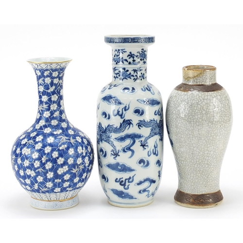 977 - Three Chinese porcelain vases including a Rouleau vase hand painted with a dragon, the largest 23cm ... 