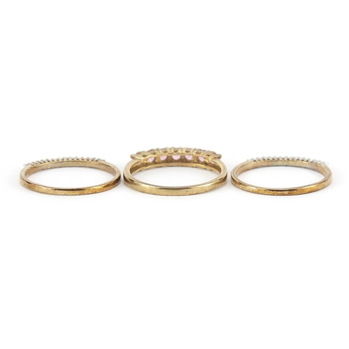 170 - Three 9ct gold half eternity rings set with diamonds and pink stones, sizes N/O, 3.9g