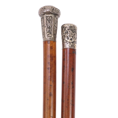 941 - Two malacca walking sticks with Chinese silver pommels embossed with figures and calligraphy, the la... 