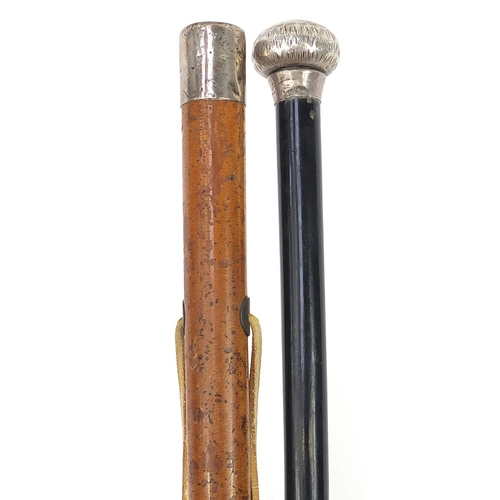 946 - Two walking sticks with silver pommels including one with malacca shaft, the largest 90cm in length