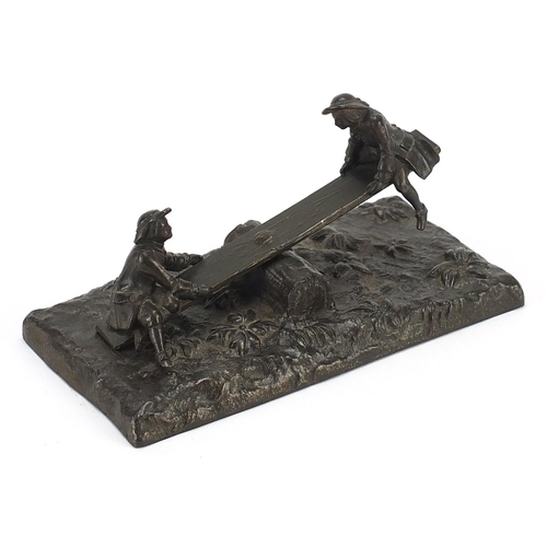 913 - 19th century bronzed metal letter clip in the form of two figures on a see-saw, 16.5cm wide