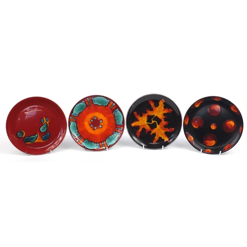 887 - Four Poole Pottery plates including Volcano and Odyssey patterns, each 21.5cm in diameter