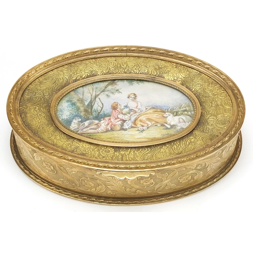 881 - French gilt brass jewel casket engraved with flowers having a hinged lid inset with an oval plaque h... 