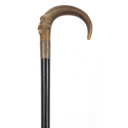 948 - Ebonised walking stick with horn handle, possibly rhinoceros, 84cm in length