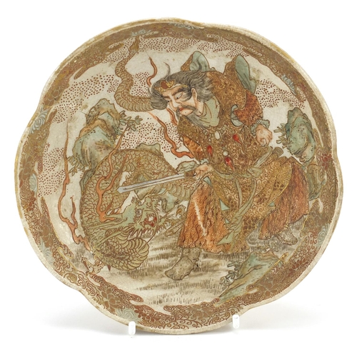 905 - Japanese Satsuma pottery dish hand painted with a demon fighting a dragon, 17cm in diameter