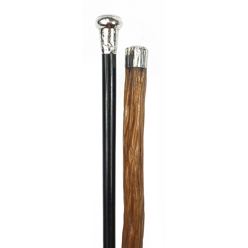 947 - Two walking sticks with silver handles including an ebonised example, the largest 91cm in length