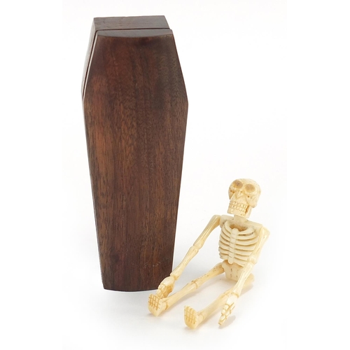 939 - Japanese carved wood coffin enclosing an articulated bone skeleton, 11.5cm high