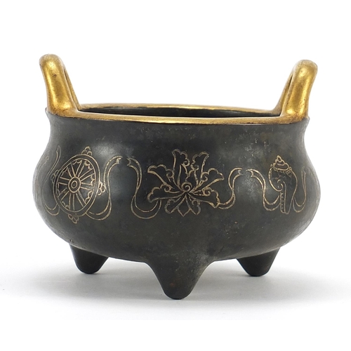 938 - Chinese Islamic patinated bronze three footed censer with silver inlay and twin handles, 12.5cm in d... 