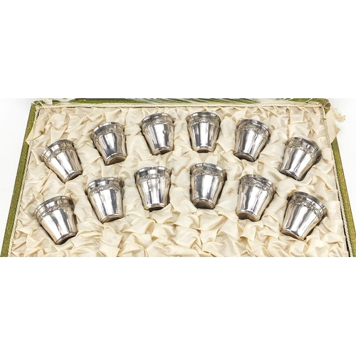 99 - Continental set of twelve silver plated liqueur cups with tray housed in a fitted silk lined box, re... 