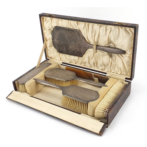 95 - Henry Matthews, George V silver backed six piece dressing table set housed in a velvet and silk line... 