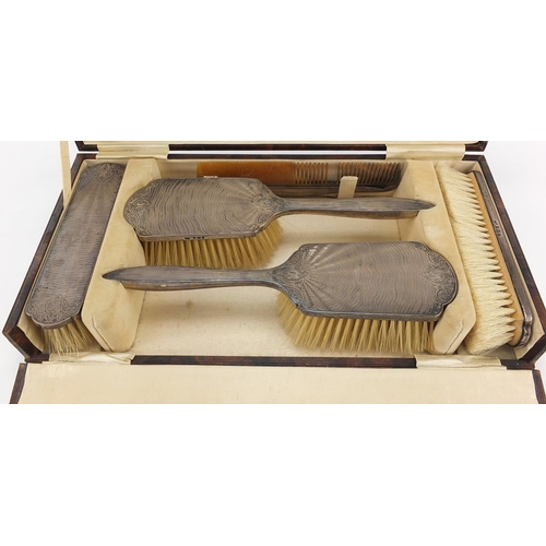 95 - Henry Matthews, George V silver backed six piece dressing table set housed in a velvet and silk line... 