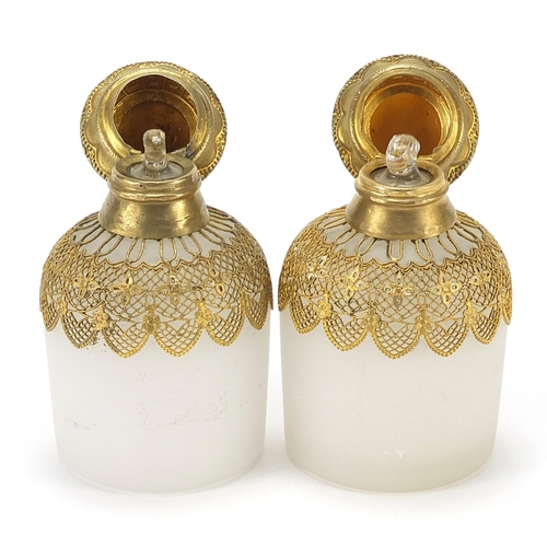 882 - Pair of continental opaline glass scent bottles with gilt metal mounts and stoppers, each 10cm high