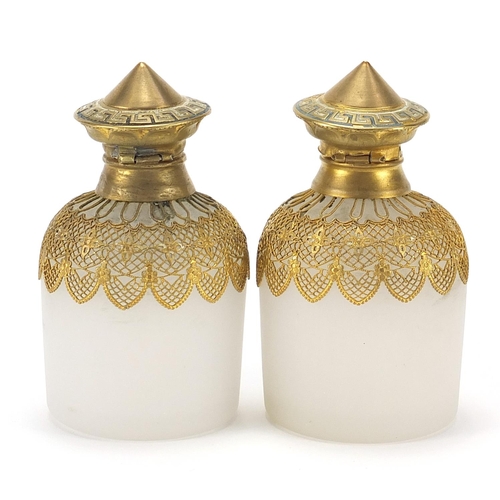 882 - Pair of continental opaline glass scent bottles with gilt metal mounts and stoppers, each 10cm high